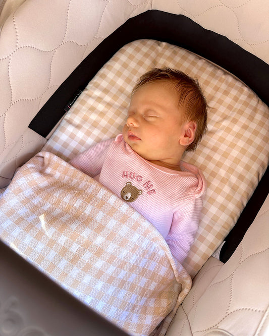 Adorable little baby in her Bugaboo Kangaroo Bassinet with Beige Gingham made by Harmony j.