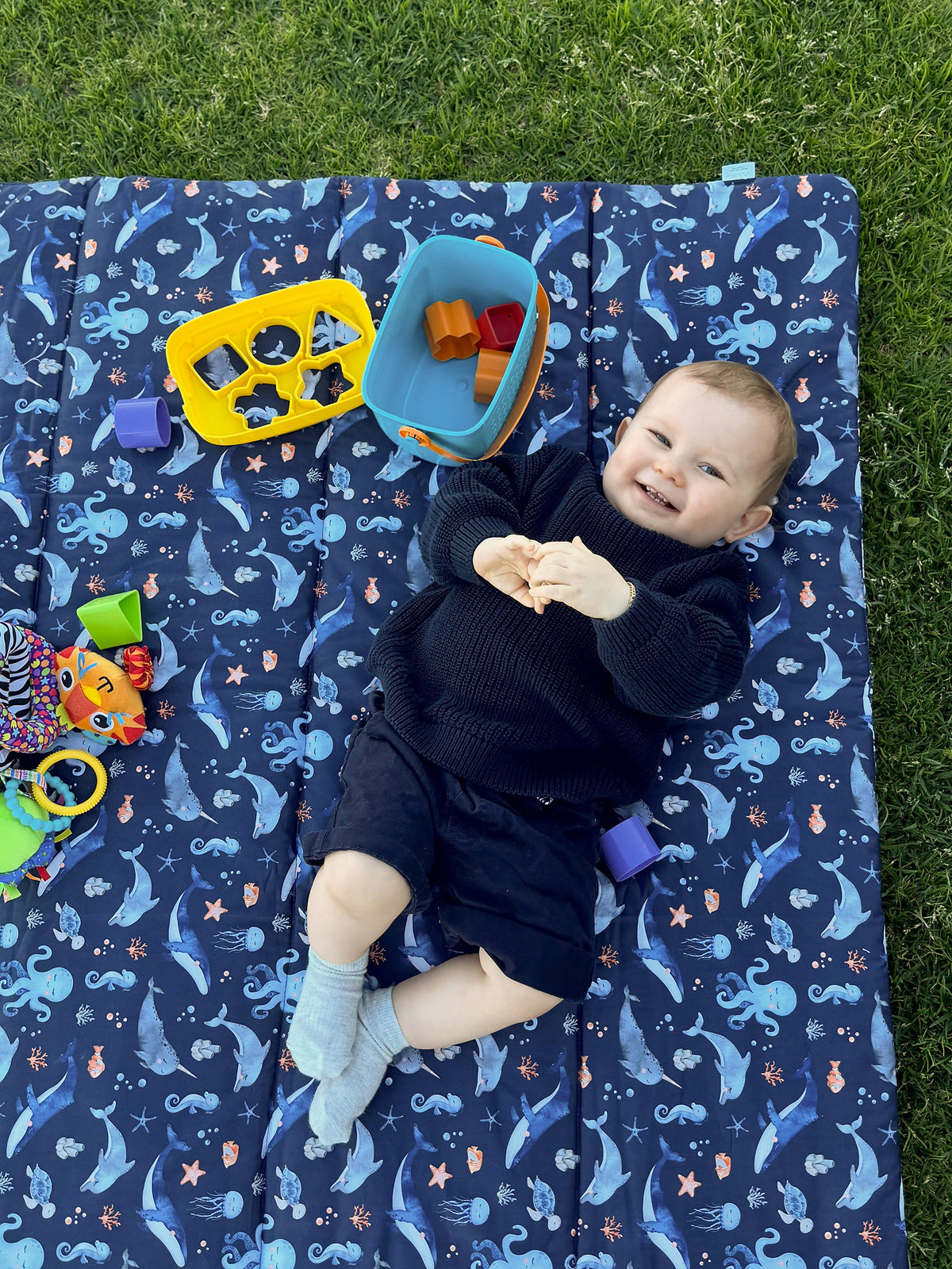 Baby Play Mat in a square shape design. Gorgeous little boy enjoying play time on his Baby Play Mat by Harmony j.