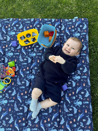 Baby Play Mat in a square shape design. Gorgeous little boy enjoying play time on his Baby Play Mat by Harmony j.