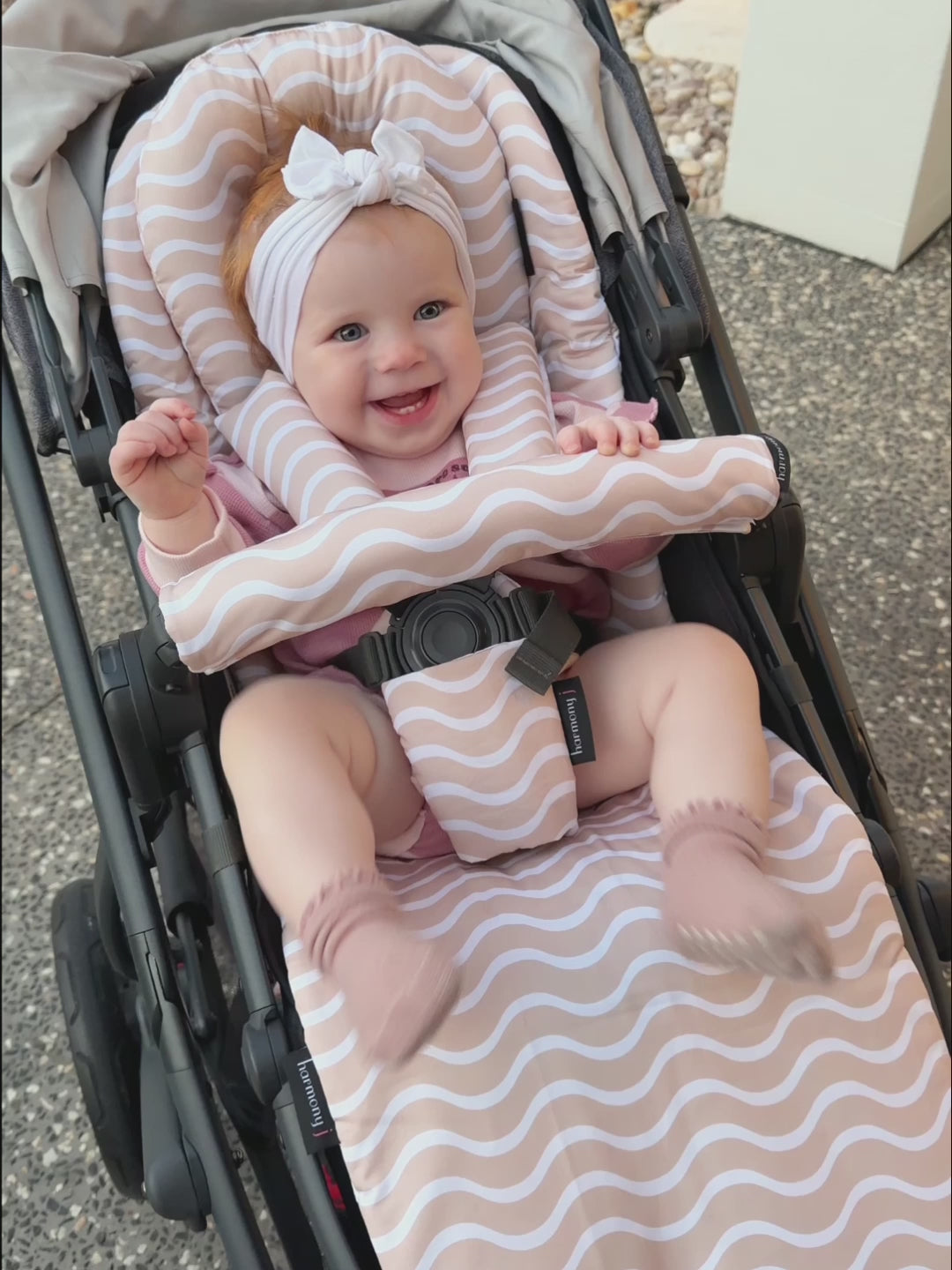 Little girl happy in here Uppababy Vista V2 pram with her pram liner and accessories.
